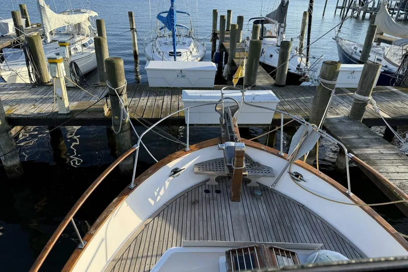 Slide: The Image of 1981 Marine Trader Double Cabin docked at marina with sailboats in background. - 44