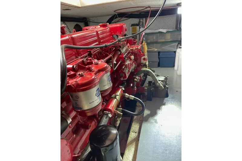 Slide: The Image of Engine room of 1981 Marine Trader Double Cabin with red engine components. - 48