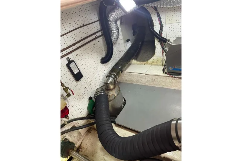 Slide: The Image of Engine room of 1981 Marine Trader Double Cabin with hoses and ventilation system. - 50