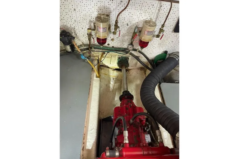 Slide: The Image of Engine room of 1981 Marine Trader Double Cabin with visible fuel filters and mechanical components. - 51