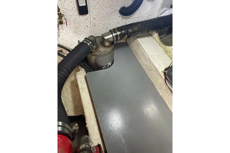 Slide: The Image of Engine room of 1981 Marine Trader Double Cabin with hoses and fittings. - 52