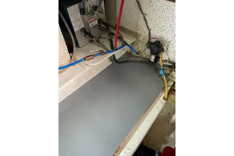 Slide: The Image of 1981 Marine Trader Double Cabin engine room with visible wiring and equipment. - 53