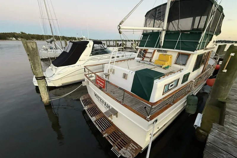 Slide: The Image of 1981 Marine Trader Double Cabin yacht docked, featuring a "For Sale" sign. - 6
