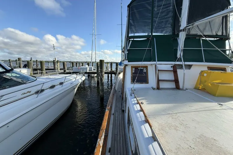 Slide: The Image of 1981 Marine Trader Double Cabin yacht docked at marina under blue sky. - 7
