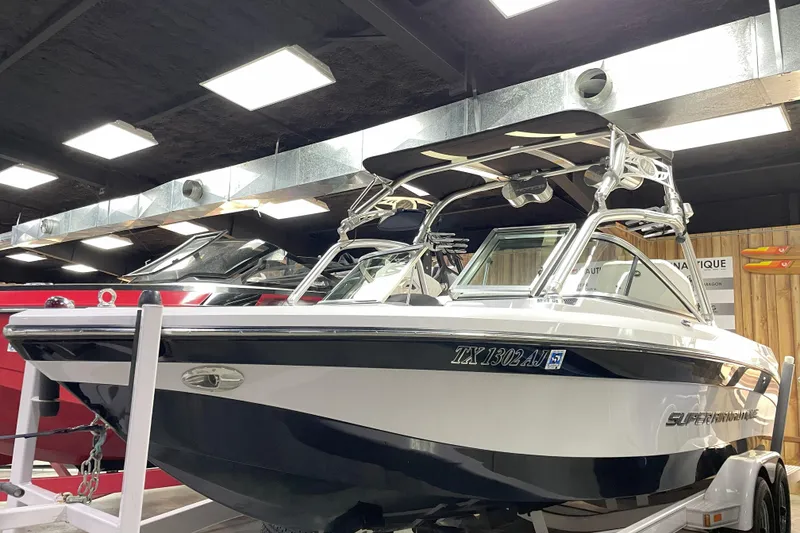 Slide: The Image of 2007 Nautique Super Air Nautique 220 boat displayed indoors on a trailer. - 2