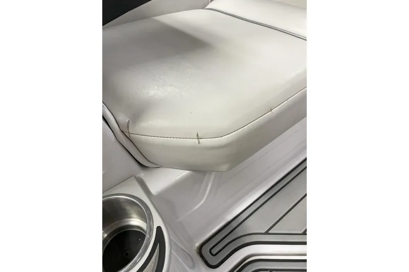 Slide: The Image of 2007 Nautique Super Air Nautique 220 boat seat with cup holder and stitching detail. - 5