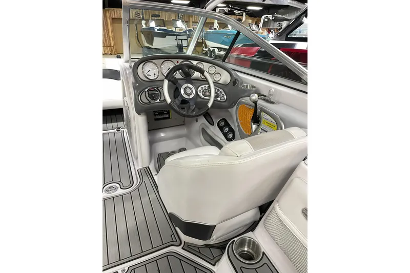Slide: The Image of 2007 Nautique Super Air Nautique 220 boat interior with steering wheel and dashboard controls. - 6