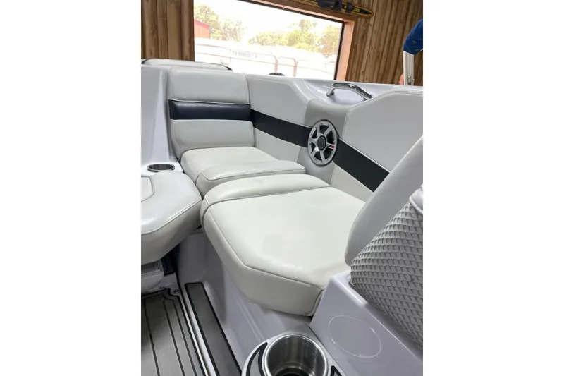 Slide: The Image of 2007 Nautique Super Air Nautique 220 interior with white leather seating and speaker. - 9