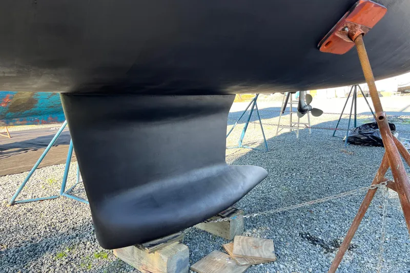 Slide: The Image of 2016 Beneteau Oceanis 35 sailboat keel on dry dock, supported by stands. - 19