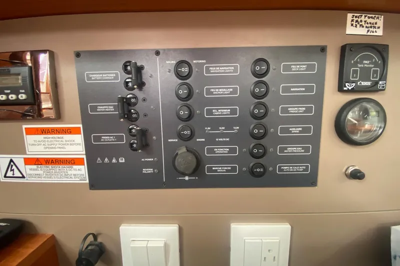 Slide: The Image of Control panel of a 2016 Beneteau Oceanis 35 sailboat with various switches and gauges. - 23