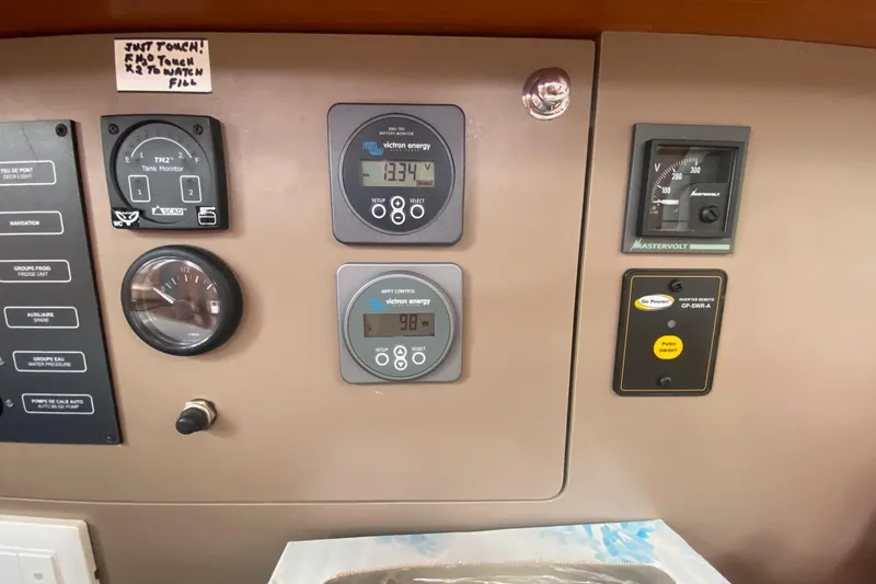 Slide: The Image of Control panel of a 2016 Beneteau Oceanis 35 sailboat with various gauges and monitors. - 24