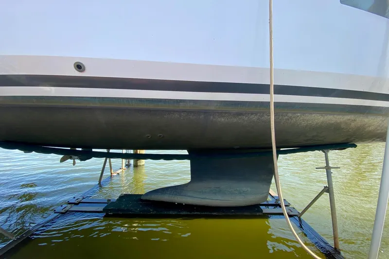 Slide: The Image of 2016 Beneteau Oceanis 35 sailboat hull and keel in dry dock. - 33