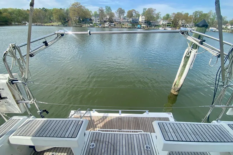 Slide: The Image of Beneteau Oceanis 35 (2016) yacht stern view, overlooking calm waters and distant shoreline. - 45