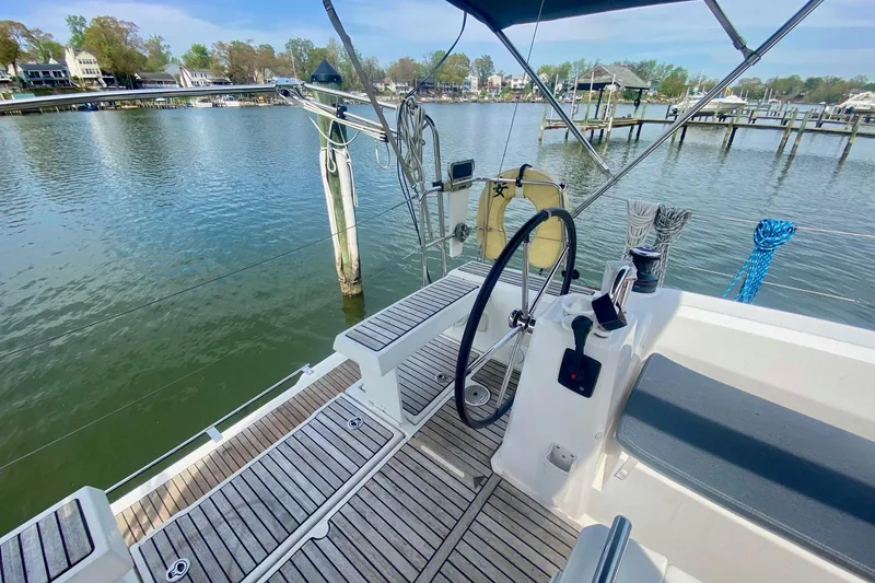 Slide: The Image of Cockpit view of 2016 Beneteau Oceanis 35 sailboat docked by serene waterfront. - 46