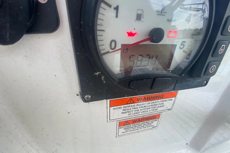 Slide: The Image of Instrument panel of a 2016 Beneteau Oceanis 35 sailboat with warning labels. - 52