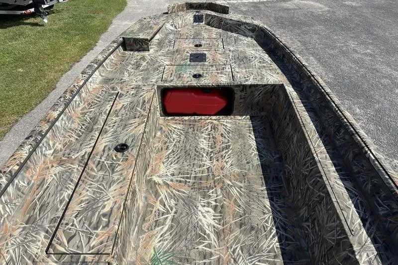 Slide: The Image of 2026 SeaArk 1752 Slayer boat with camouflage design, featuring storage compartments. - 10