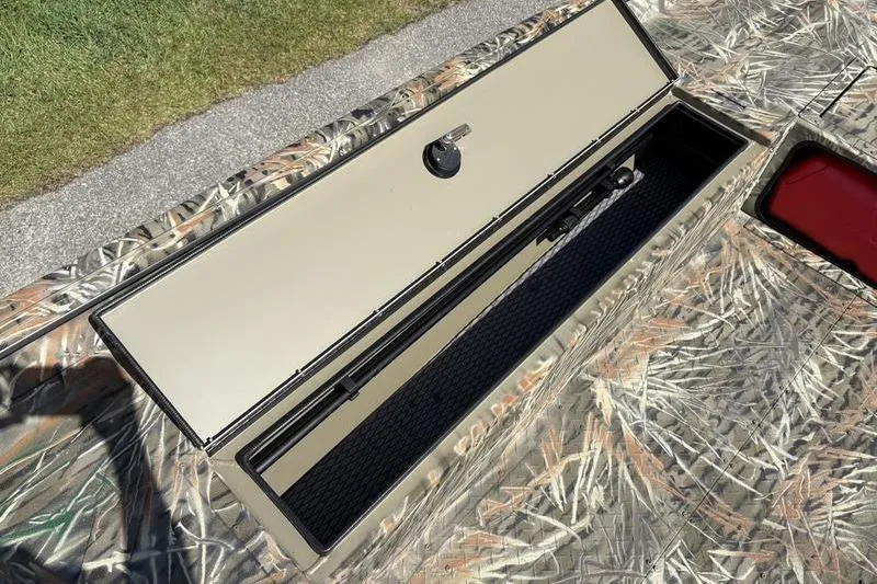 Slide: The Image of 2026 SeaArk 1752 Slayer boat with open storage compartment, camo design. - 11