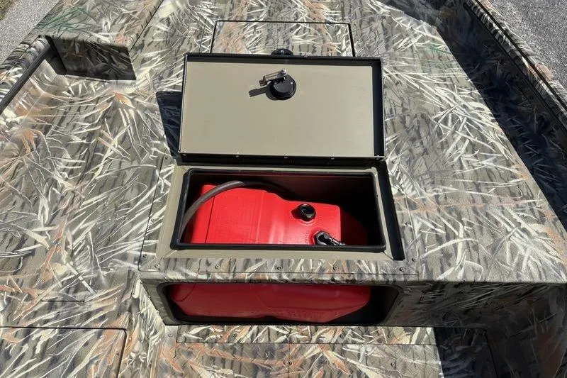 Slide: The Image of Camouflage SeaArk 1752 Slayer boat with open storage compartment revealing a red fuel tank. - 12