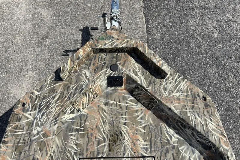 Slide: The Image of Camouflage-patterned 2026 SeaArk 1752 Slayer boat on pavement, showcasing bow design. - 15
