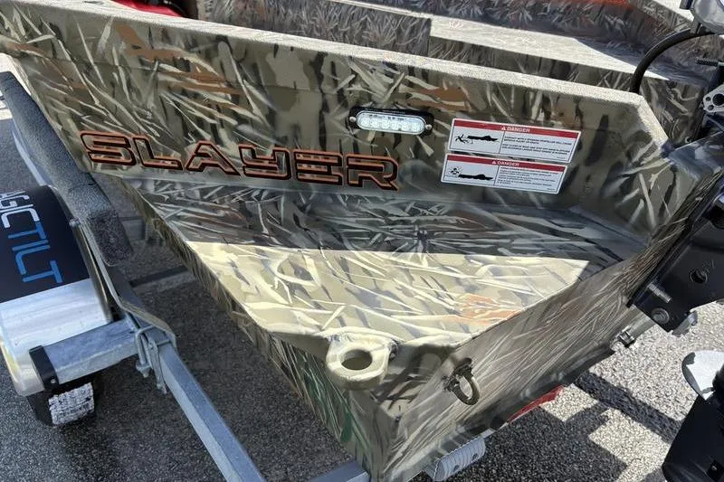 Slide: The Image of 2026 SeaArk 1752 Slayer boat with camouflage design on a trailer. - 18
