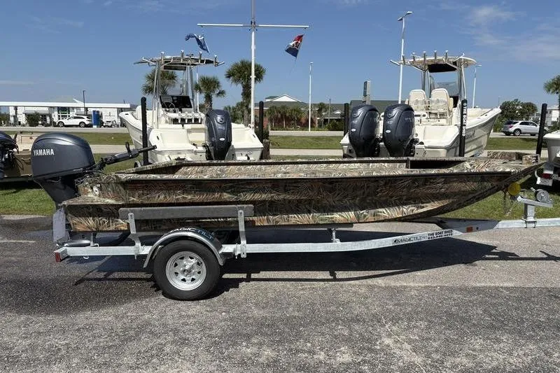 Slide: The Image of 2026 SeaArk 1752 Slayer boat with Yamaha motor on trailer, parked outdoors. - 4