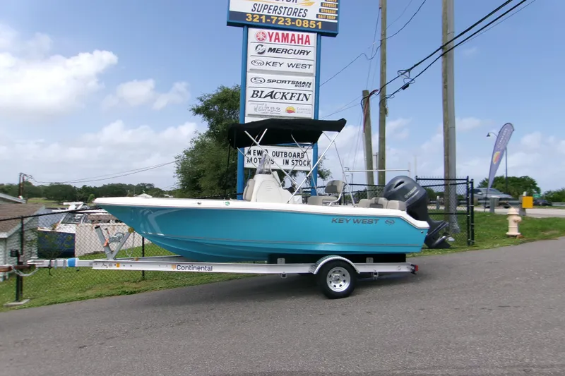 The Image of 2026 Key West 189 FS boat on trailer at dealership, clear sky background. - 0