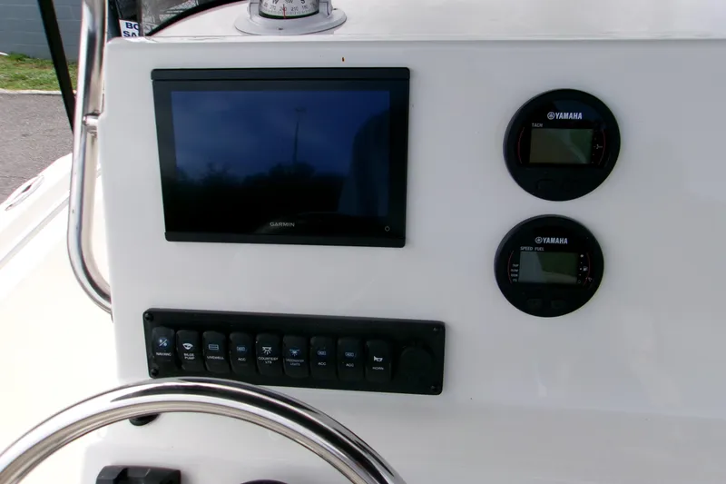 Slide: The Image of 2026 Key West 189 FS boat dashboard with Garmin display and Yamaha gauges. - 11
