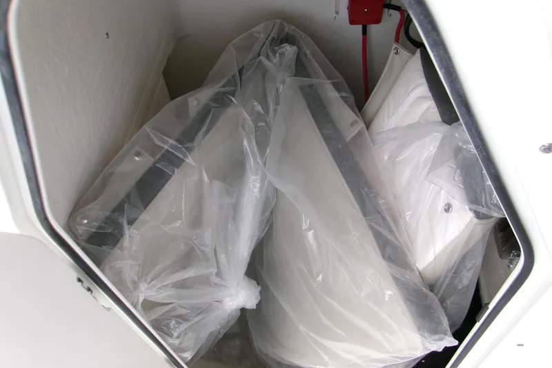 Slide: The Image of Storage compartment of 2026 Key West 189 FS boat with wrapped items inside. - 12