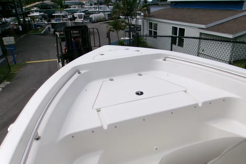 Slide: The Image of 2026 Key West 189 FS boat bow view at marina, showcasing sleek design and storage compartment. - 13