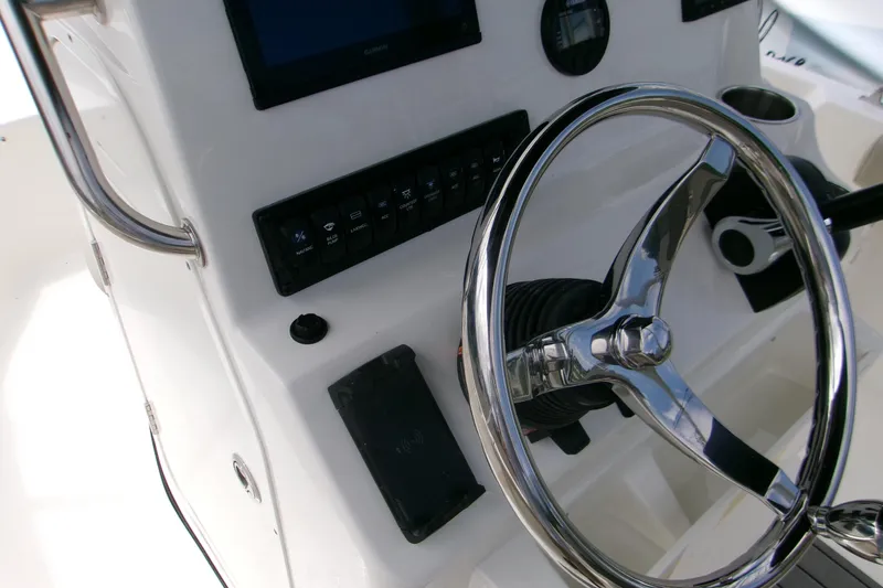 Slide: The Image of Steering console of 2026 Key West 189 FS boat with chrome wheel and controls. - 16