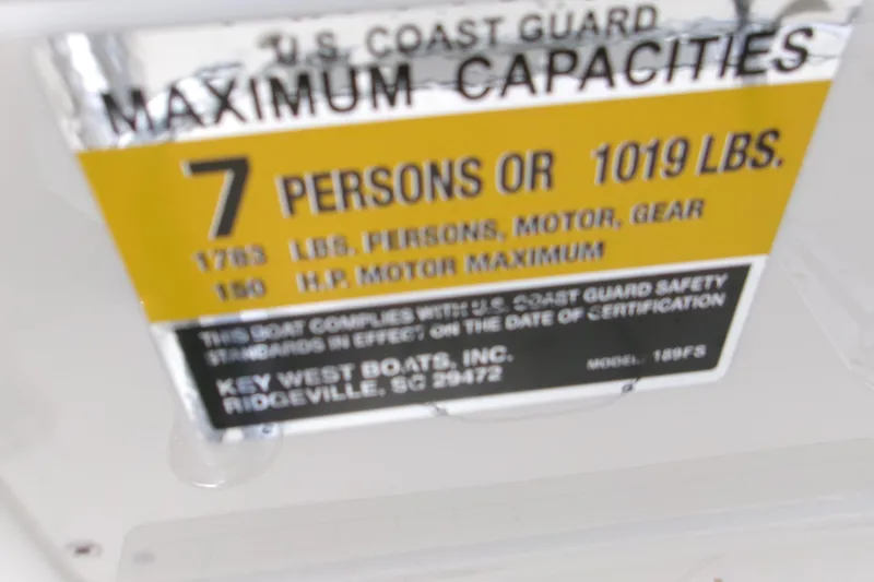 Slide: The Image of Key West 189 FS 2026 boat capacity label, 7 persons or 1019 lbs, U.S. Coast Guard compliant. - 18