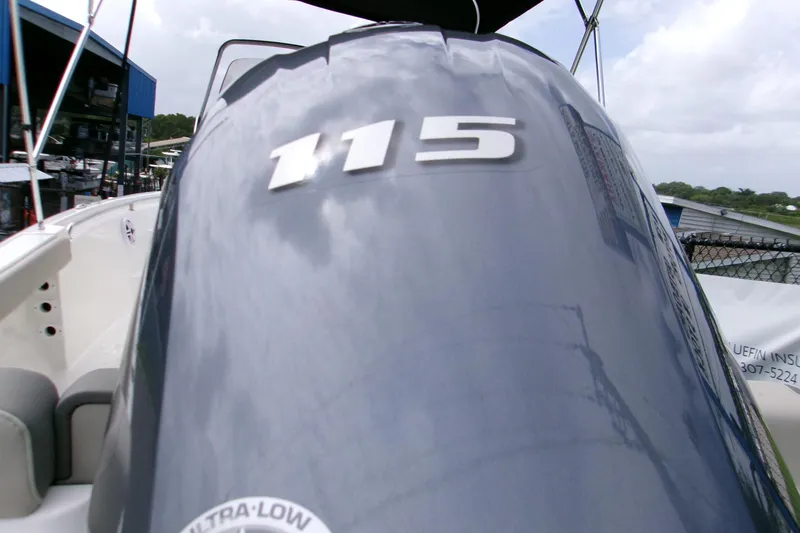 Slide: The Image of 2026 Key West 189 FS boat with 115 horsepower engine, docked outdoors. - 9