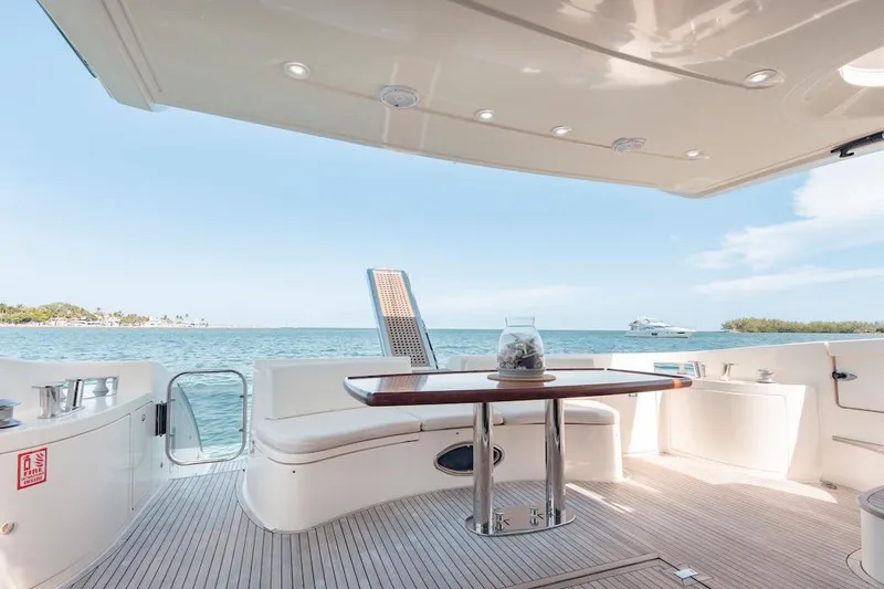 Slide: The Image of Luxurious 2007 Azimut 62 Evolution yacht deck with ocean view and elegant seating area. - 22