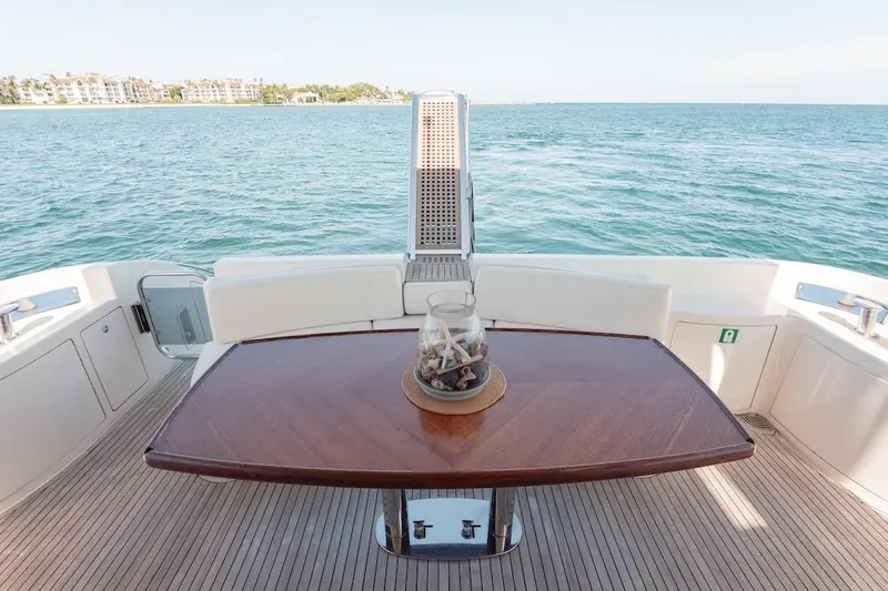 Slide: The Image of 2007 Azimut 62 Evolution yacht deck with elegant wooden table and ocean view. - 23