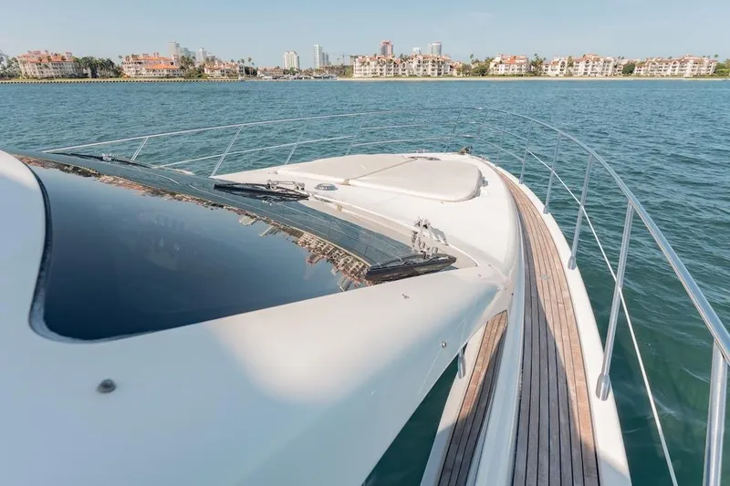 Slide: The Image of 2007 Azimut 62 Evolution yacht cruising on calm waters near a coastal city. - 30