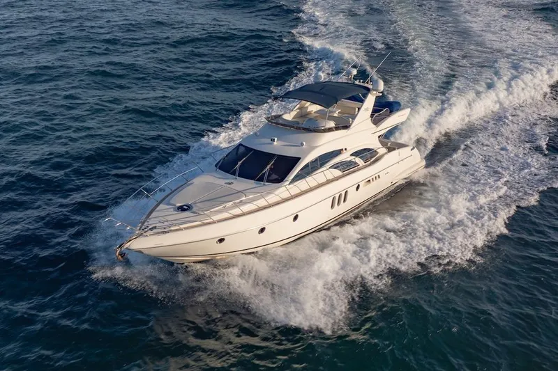 Slide: The Image of 2007 Azimut 62 Evolution yacht cruising on open water, creating a dynamic wake. - 4