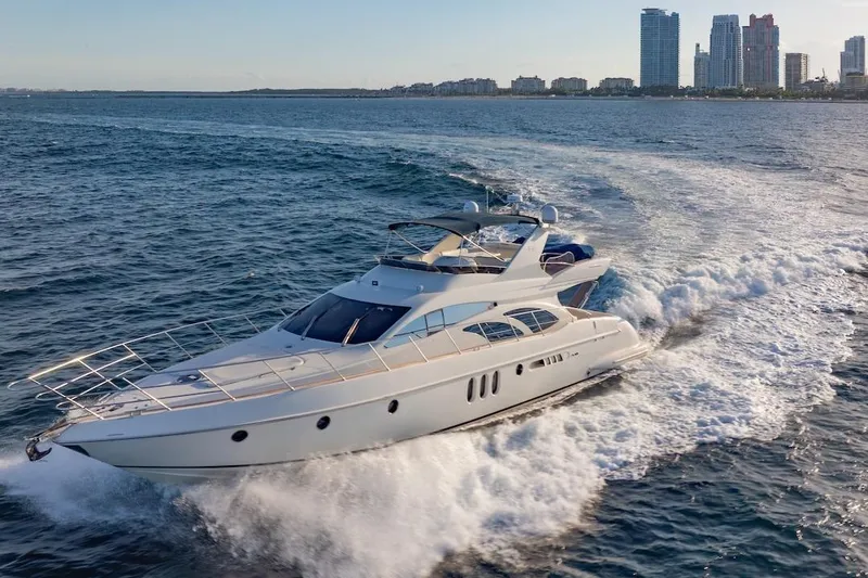 Slide: The Image of 2007 Azimut 62 Evolution yacht cruising near city skyline on open water. - 6