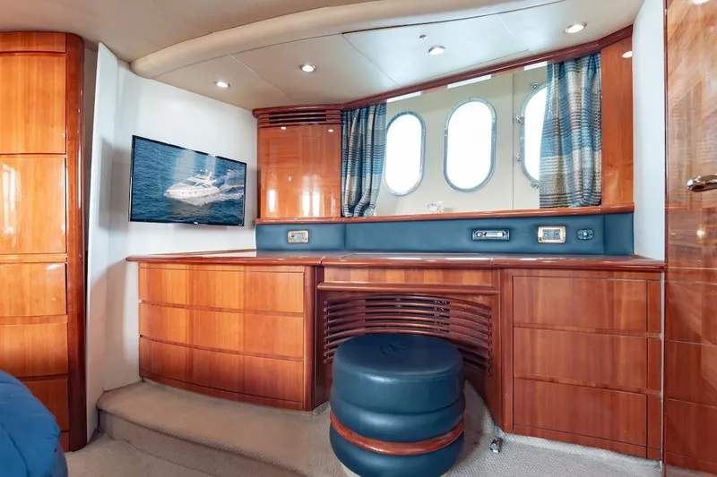 Slide: The Image of Luxurious interior of 2007 Azimut 62 Evolution yacht with wood cabinetry and porthole windows. - 63