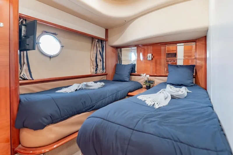 Slide: The Image of Luxurious twin cabin in 2007 Azimut 62 Evolution yacht, featuring elegant wood finishes. - 67