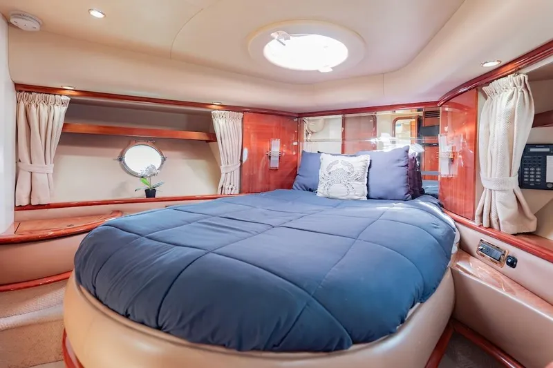 Slide: The Image of Luxurious bedroom interior of 2007 Azimut 62 Evolution yacht with elegant wood finishes. - 68