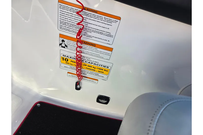 Slide: The Image of 2012 Sea-Doo 210 Wake boat warning labels and safety instructions with red cord. - 13