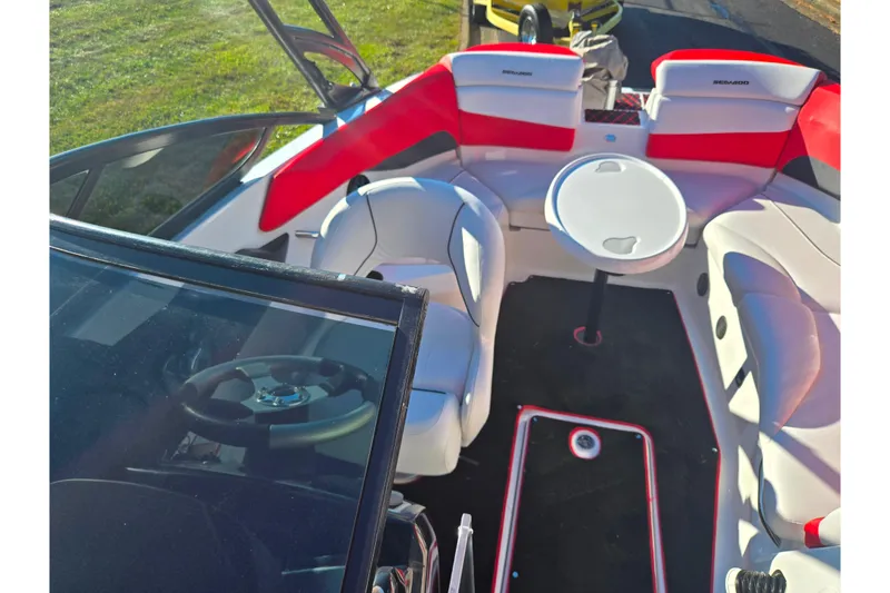 Slide: The Image of 2012 Sea-Doo Sport Boats 210 Wake interior with seating and table, showcasing modern design. - 21