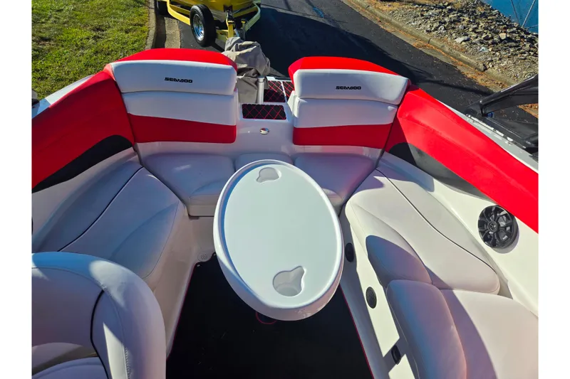 Slide: The Image of 2012 Sea-Doo Sport Boats 210 Wake interior with red and white seating and round table. - 22