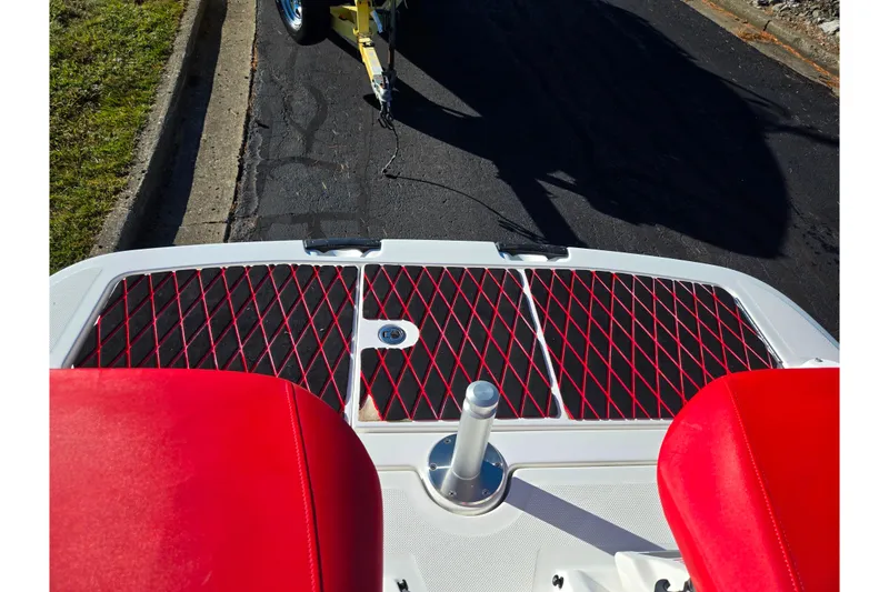 Slide: The Image of 2012 Sea-Doo 210 Wake boat with red seats and black deck mat. - 24