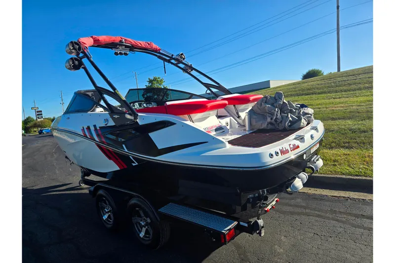 Slide: The Image of 2012 Sea-Doo Sport Boats 210 Wake on trailer, parked outdoors, sunny day. - 3