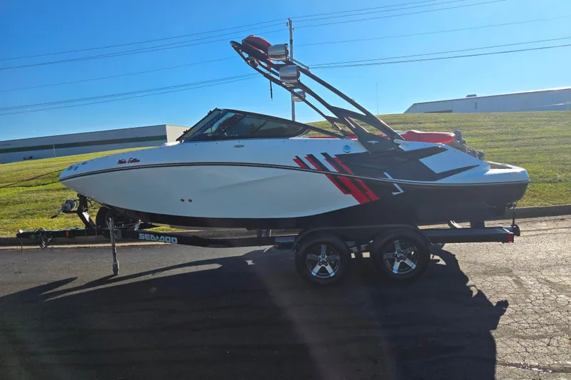 Slide: The Image of 2012 Sea-Doo Sport Boats 210 Wake on trailer, parked outdoors under clear sky. - 4