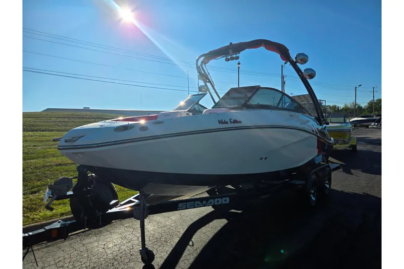 Slide: The Image of 2012 Sea-Doo Sport Boats 210 Wake on trailer under bright sun. - 5