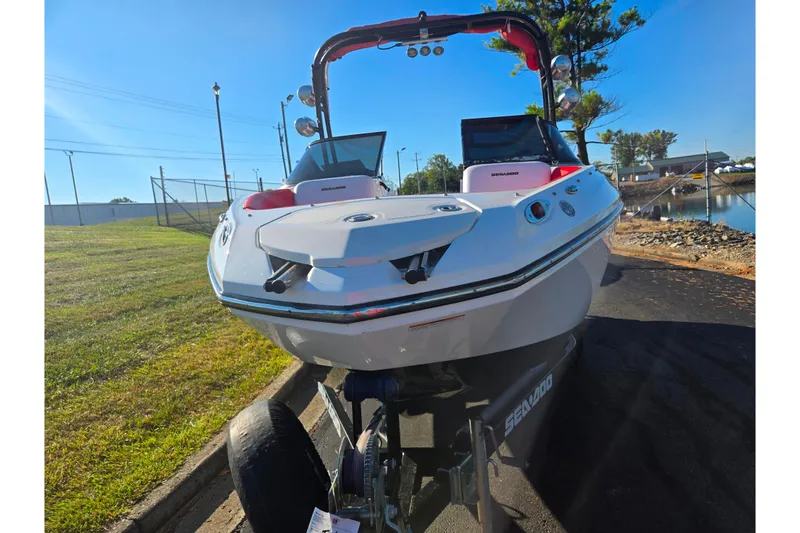Slide: The Image of 2012 Sea-Doo Sport Boats 210 Wake on trailer, parked near water, sunny day. - 6