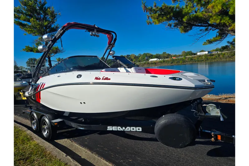 Slide: The Image of 2012 Sea-Doo Sport Boats 210 Wake on trailer by a lake. - 8