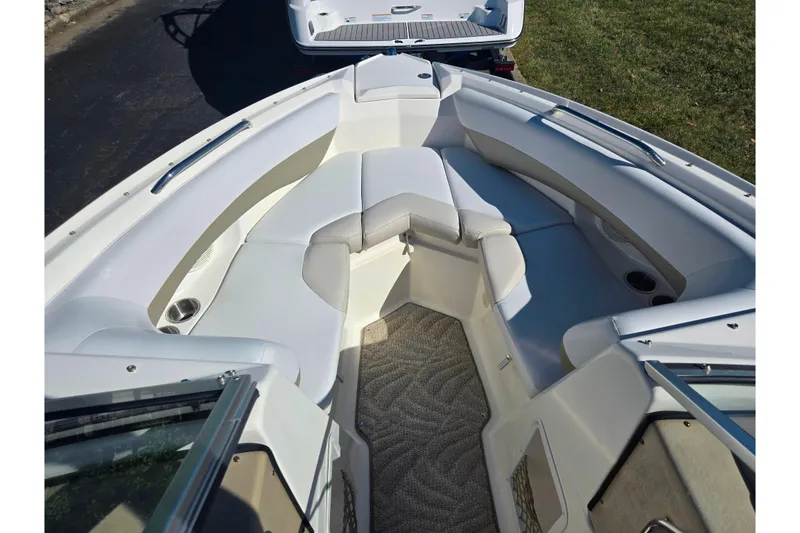 Slide: The Image of 2007 Larson LXi 228 boat interior with white seating and carpeted floor. - 16